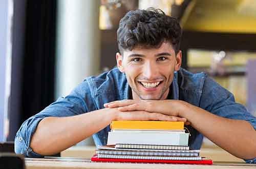 Happy boy with books